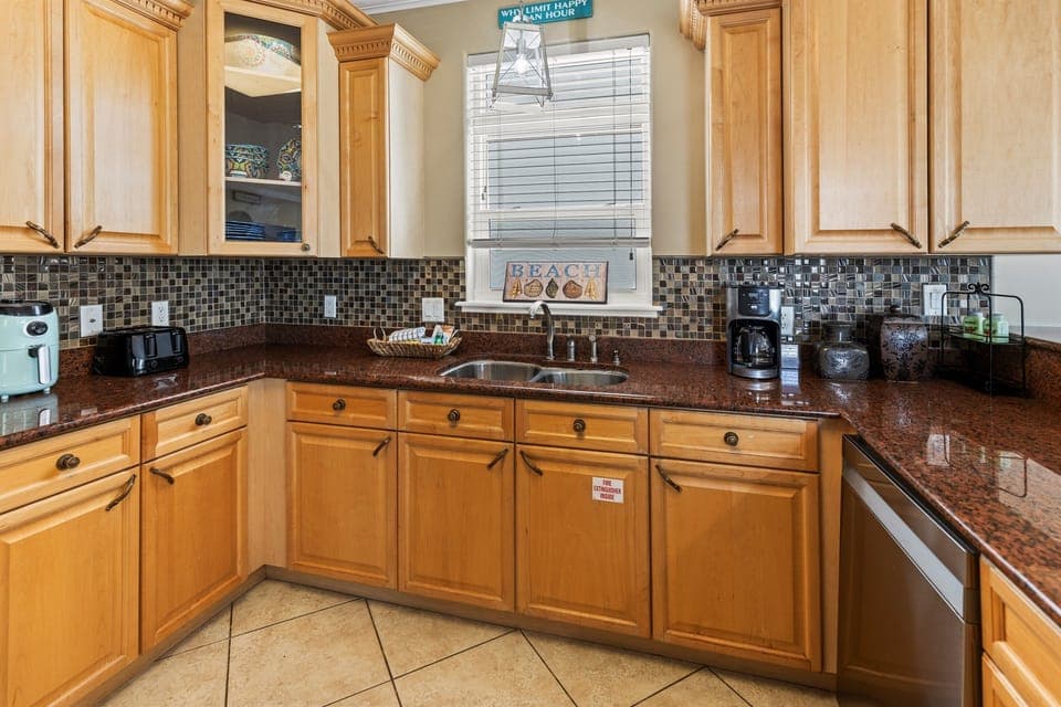 Your fully equipped kitchen awaits with granite counters, coffee maker, and coastal charm for memorable meal prep.