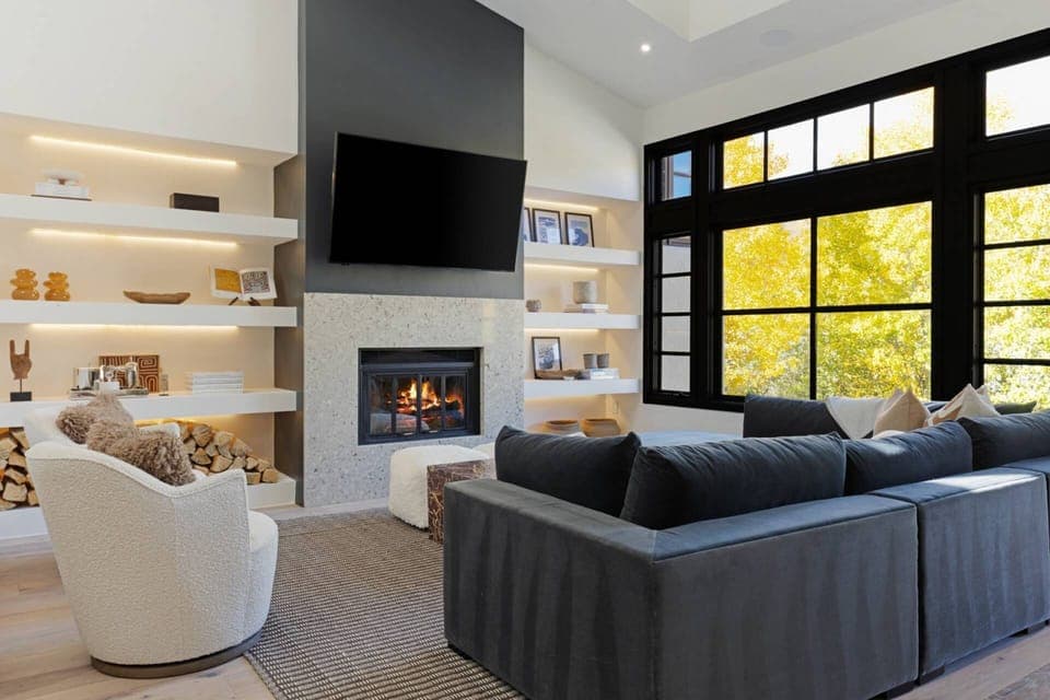 The Living Room features a large sectional with additional rotating chairs and large flat screen tv.