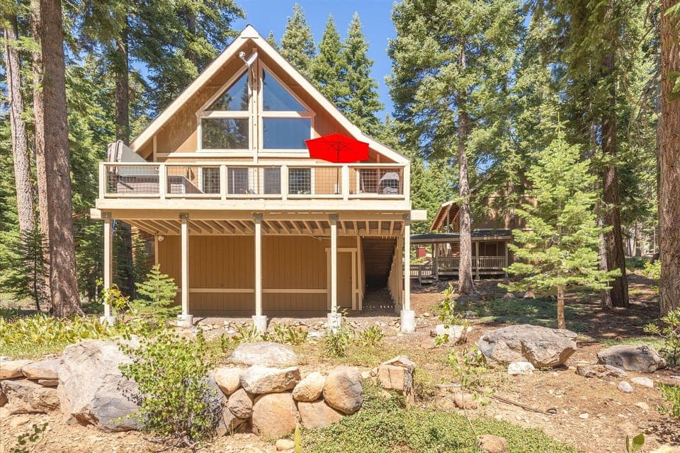 A glimpse from the Tahoe forest to the inviting beauty of the home's deck.