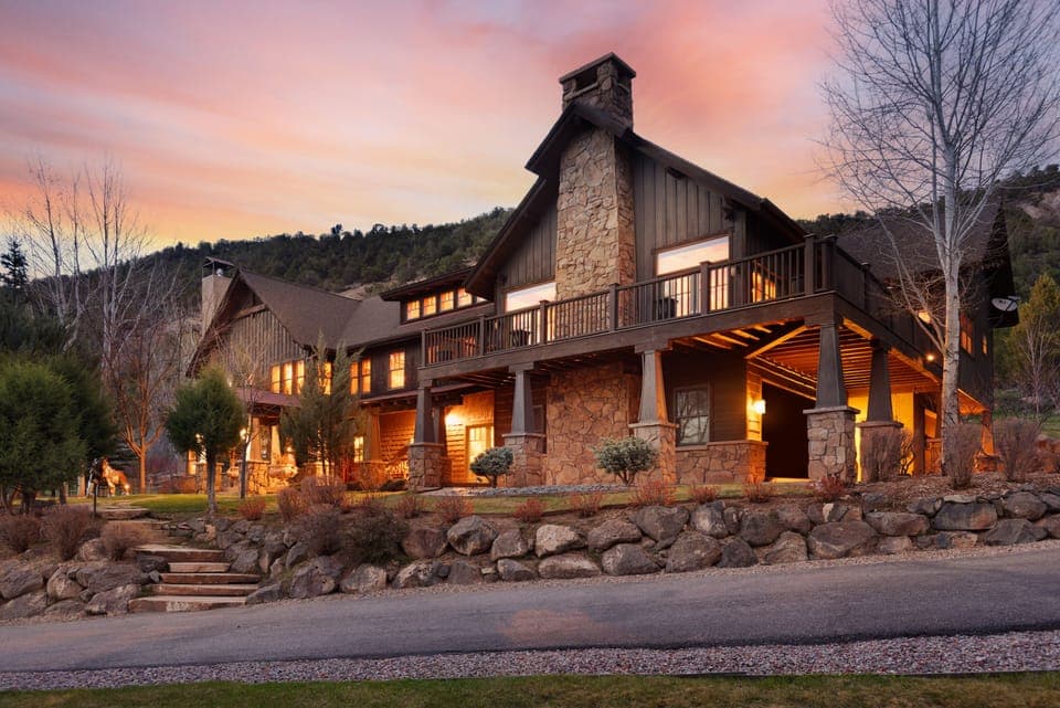 Front view of home which backs to an open space hillside.