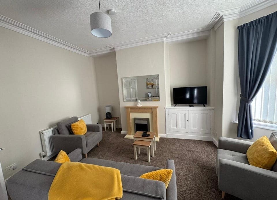 The stylish living area benefitting from a Smart TV with Netflix and a comfortable sofa.