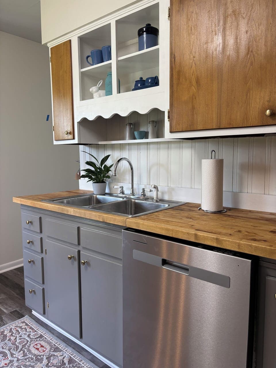 Alternate angle of kitchen sink and charming open cabinet space