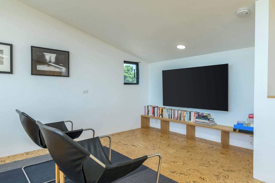 Great loft space with two twin beds, a reading area, and large smart tv