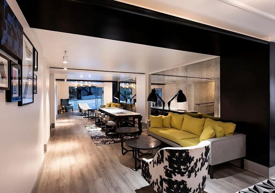 Unwind on the vibrant sofa in a designer lounge setting.