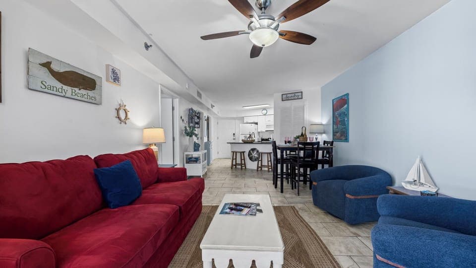 Bright living room with cozy sofa, balcony views, and plenty of natural light.
