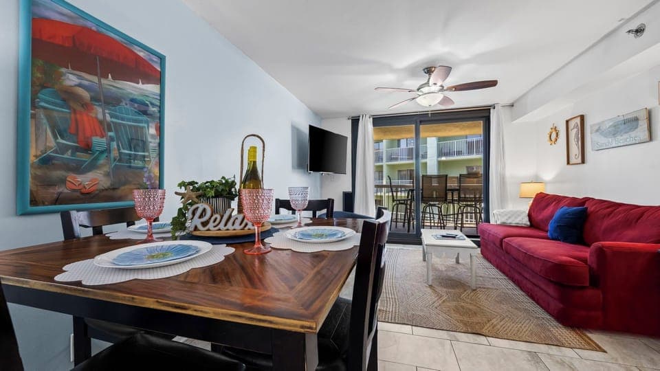 Open dining area with seating for four, flowing into the living room.