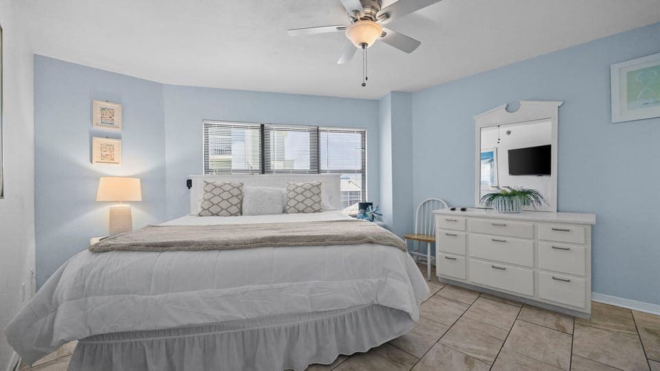 Spacious bedroom with king bed, soft linens, and plenty of natural light.