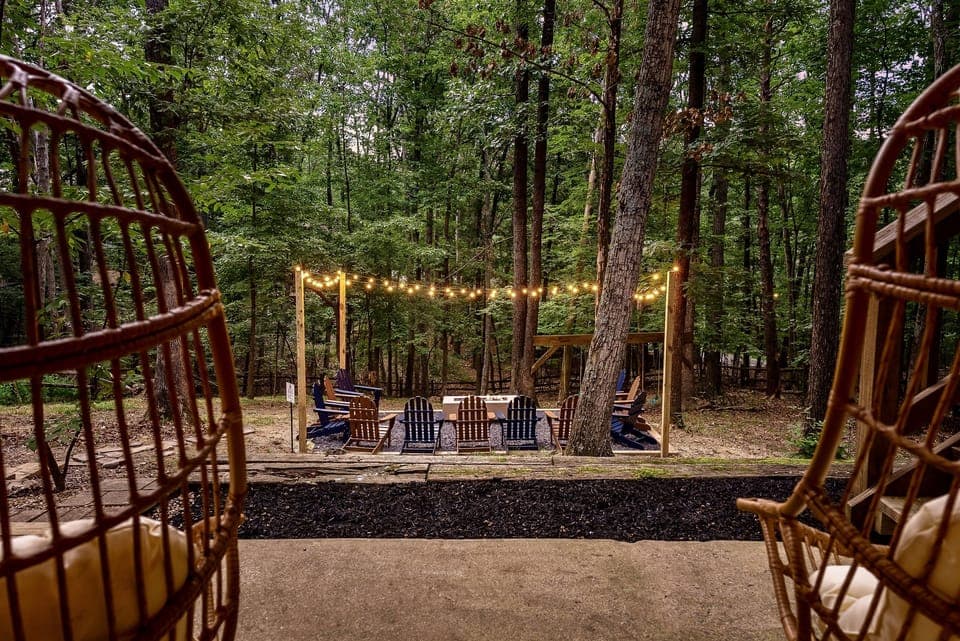An enchanting fireside retreat—string lights, forest views, and the perfect setting for unforgettable evenings. Your private escape awaits.