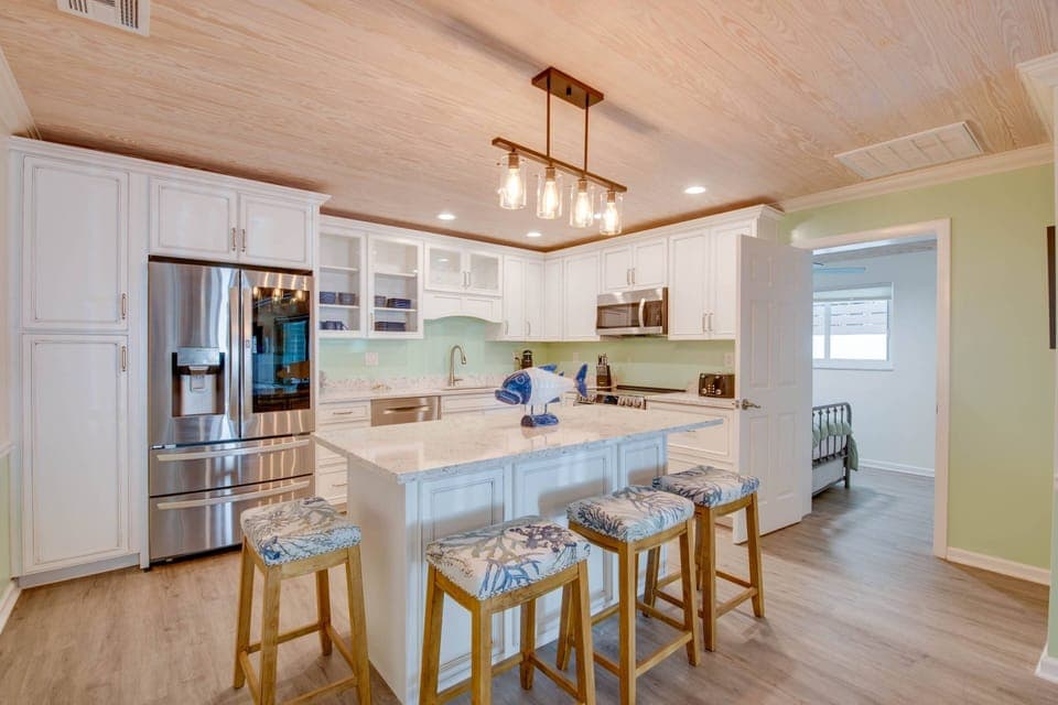 A stylish kitchen island with stools, perfect for casual meals and gathering.”