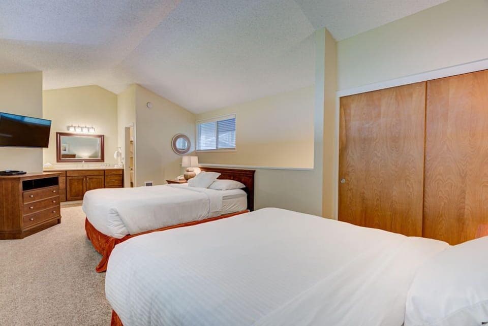 This spacious Panoramic Ocean View Loft features two comfortable queen beds and a cozy layout, perfect for relaxing after a day by the beach.