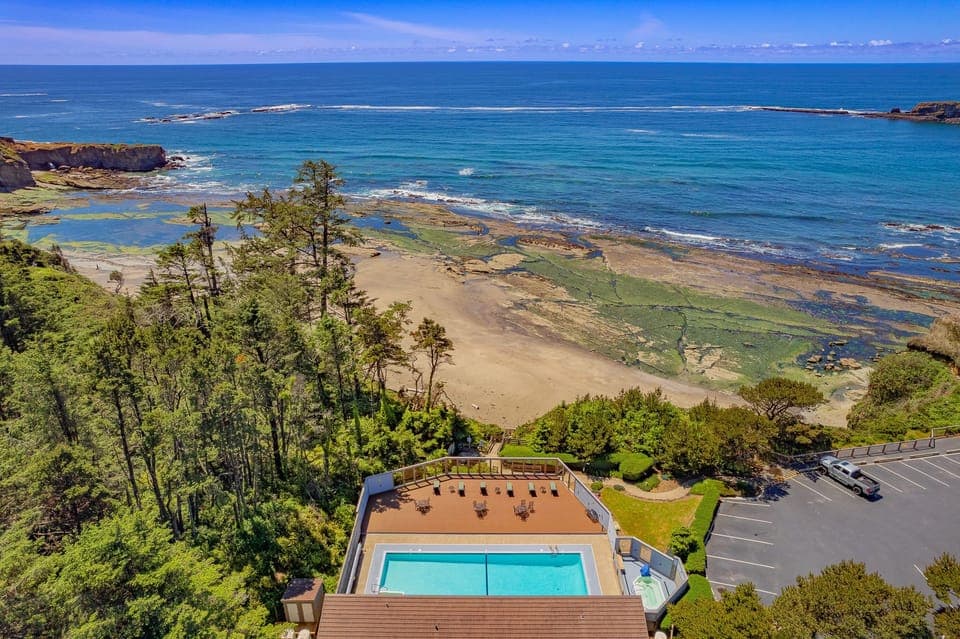 With picturesque views of the sandy beach and rocky shoreline, the pool area offers a relaxing retreat in a scenic natural setting.