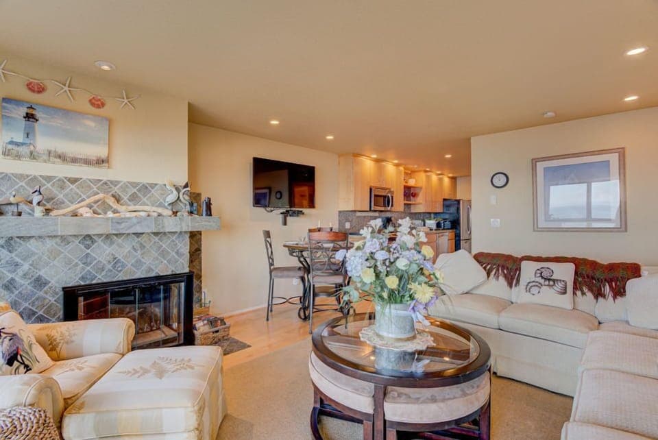 The inviting living room offers a perfect spot to relax, with its stylish furnishings and an open layout that connects to the dining area.