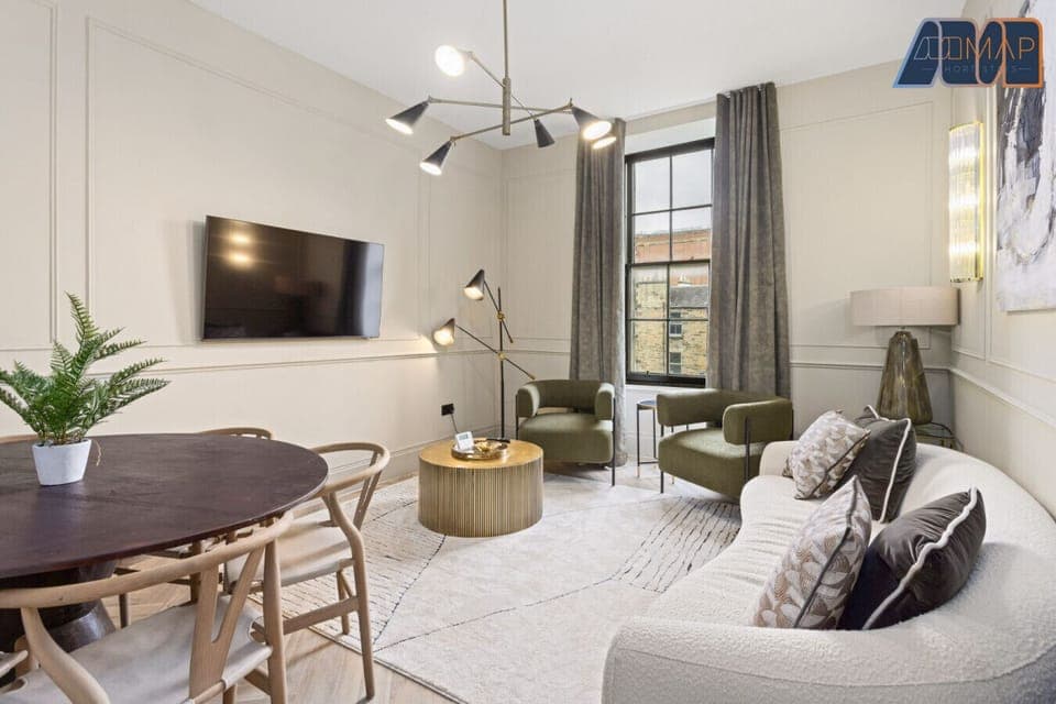 Relax in style with a spacious living room featuring a 50" Smart TV, a large sofa that comfortably seats four, and a cozy coffee table with seating for two—perfect for movie nights or winding down after a day out.