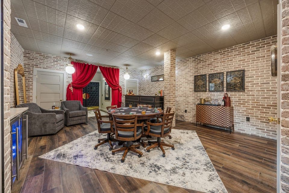 Step into cinematic charm with this dramatic entrance to a private theater room, adorned with plush red curtains and elegant lighting. A perfect mix of Hollywood glamour and cozy retreat for movie nights or poker games.