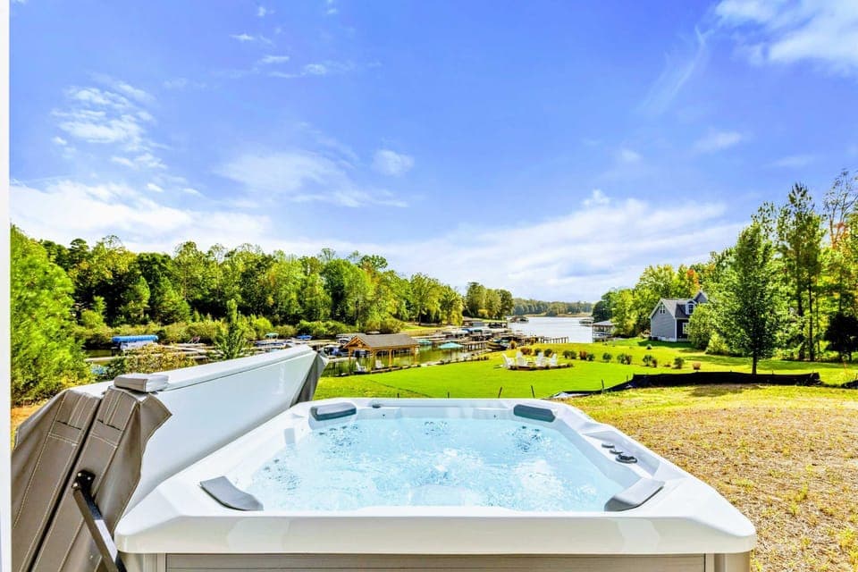Hot Tub - Soak in the hot tub with sweeping views of the lake, lawn, and dock area stretching out below.