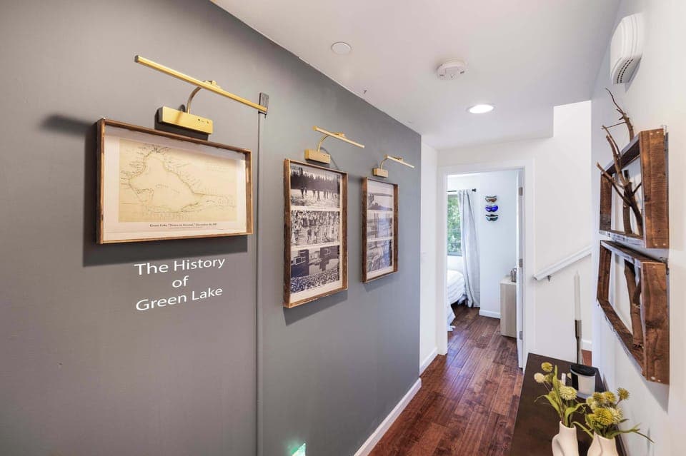 Hallway Gallery – Features framed historical prints with accent lighting, adding both style and a storytelling element to the home.