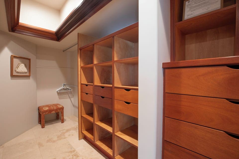Your spacious walk-in closet offers custom wood shelving and drawers for organized luxury living.