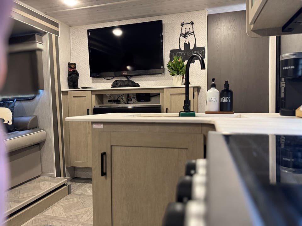 From the Bears Den to the heart of the home — kitchen and living room in view.