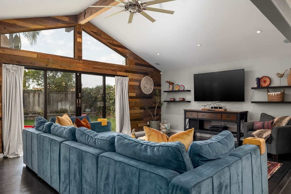 Living room 1 with ceiling fan, TV, large windows