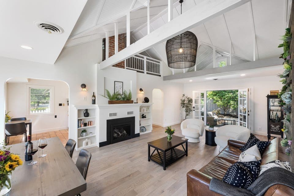Open concept elegant living room with natural light, fireplace, and Smart TV.