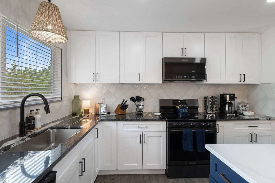 The kitchen is fully stocked with dishes, cookware, utensils, glasses and everything else you could need to cook a delicious meal. 