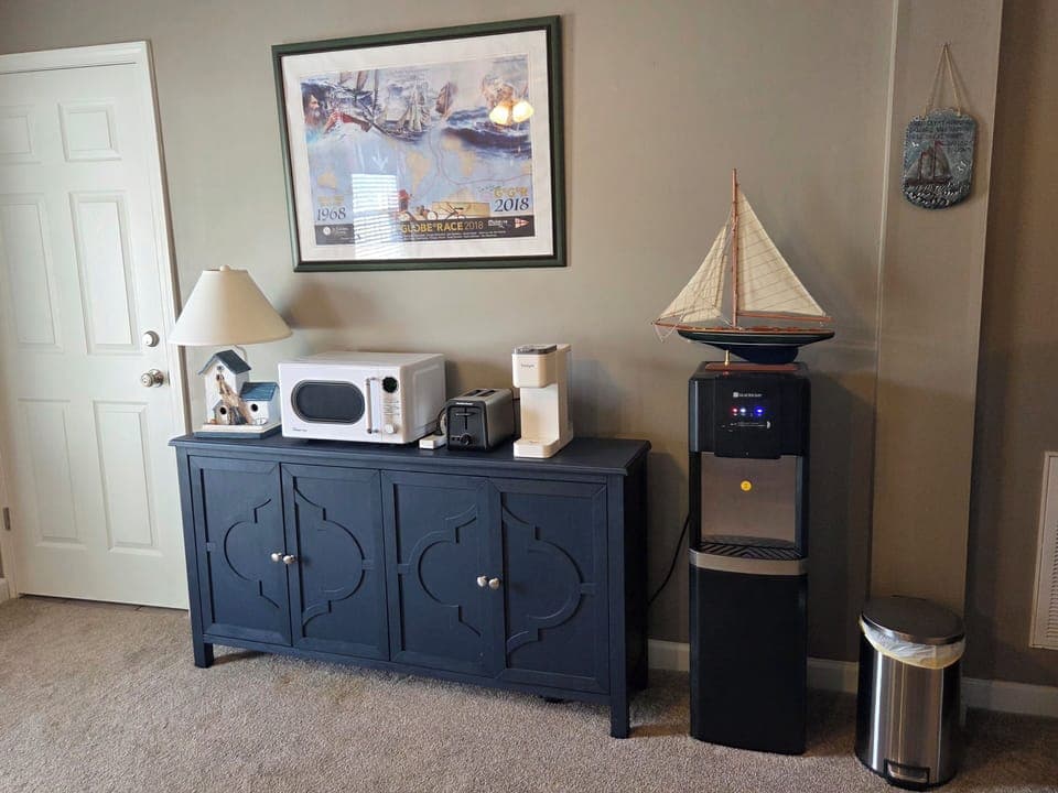 Credenza provides cupboards for food storage. Bottled water dispenser for water.