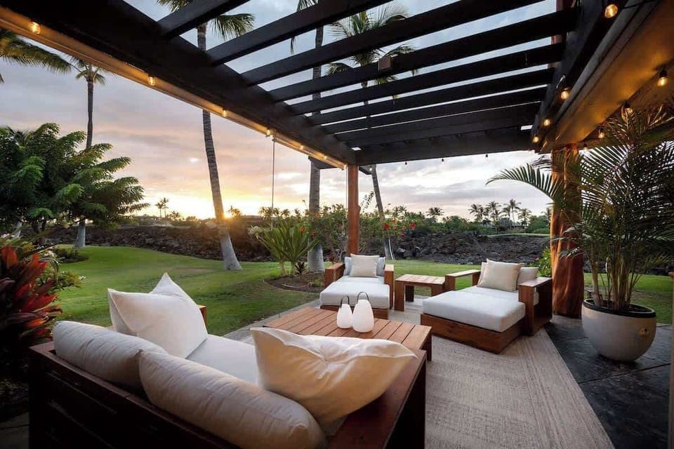 Covered patio with lounge seating and garden view