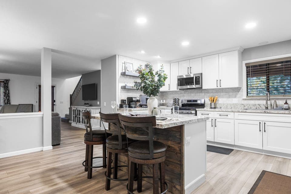 Kitchen with barstool seating and open layout.