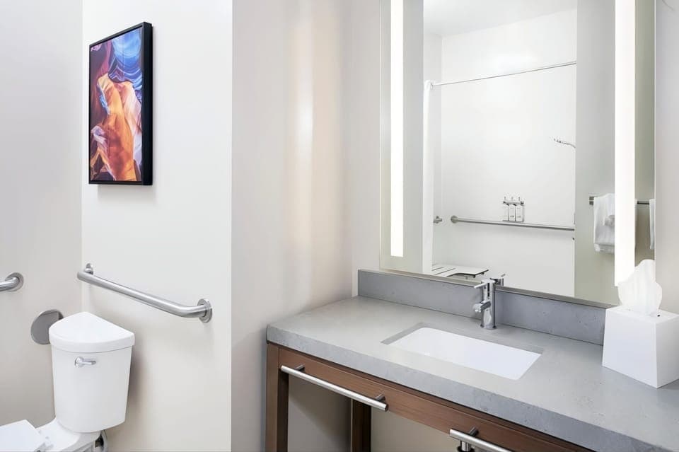 Start mornings smoothly with sleek sink, lighting, and fresh towels.