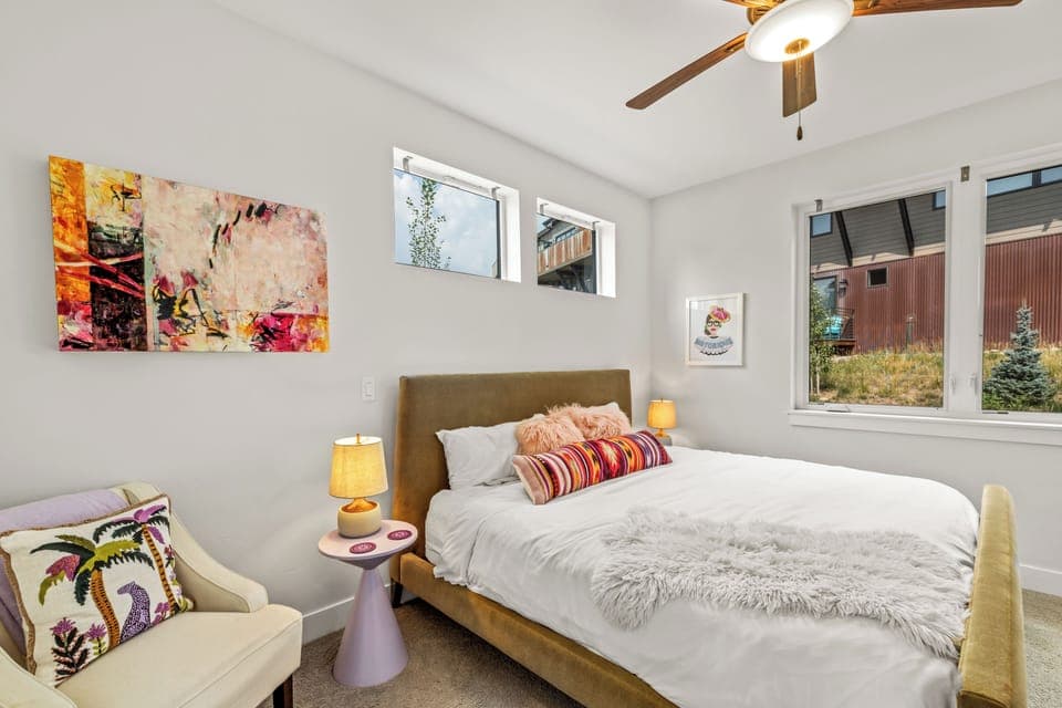 Entry level bedroom with king bed and mini-split AC unit