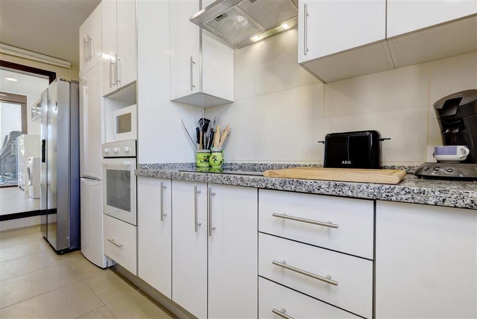 Modern high-quality kitchen is fully equipped with all the appliances and a laundry room to the rear