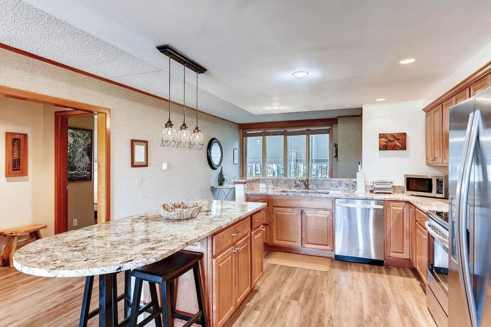 Cook and entertain in this modern kitchen, boasting elegant granite countertops and stainless steel appliances, perfect for family gatherings.