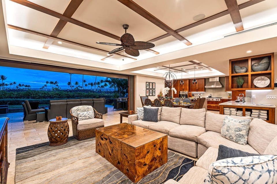 Open-concept great room with plush seating flows seamlessly to the covered lanai at Laule'a #13.