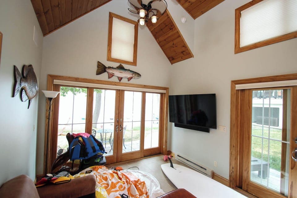 Bright, vaulted living space with natural light and cozy lakehouse charm.