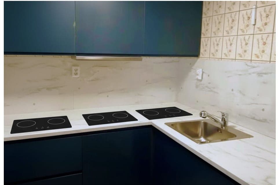 Modern kitchen with induction stove and marble backsplash