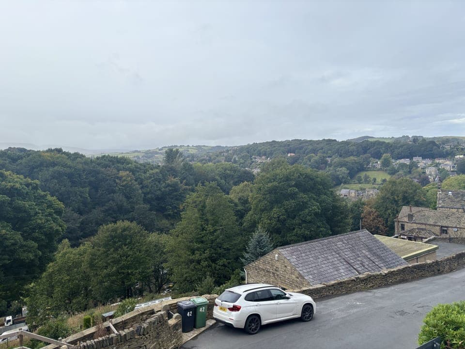 Please park where the white car is parked.