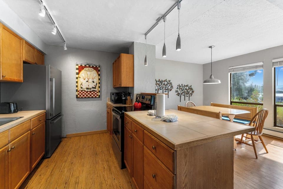 Full kitchen with stainless steel appliances.