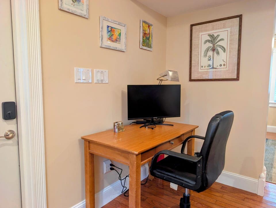Cozy work nook with monitor, task lamp, and cushy office chair