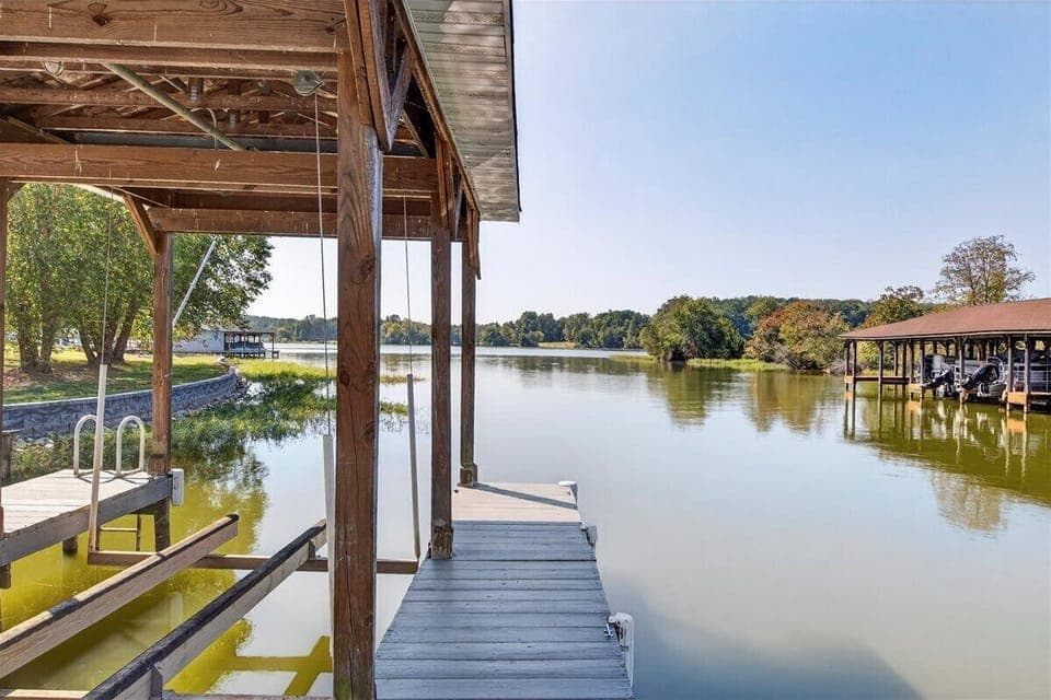 Peaceful waters stretch out from the boathouse.