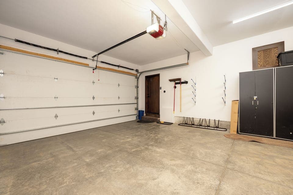 Spacious garage with convenient storage solutions and easy vehicle access for your rental stay.