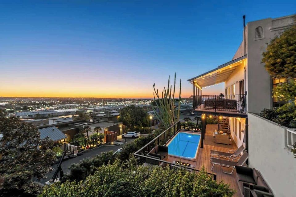 A pool with a stunning city view and balcony seating surrounding a central firepit make this space perfect for evening relaxation. As the colorful dusk gives way to night, the flickering warm lights from afar set the mood for a peaceful night ahead.