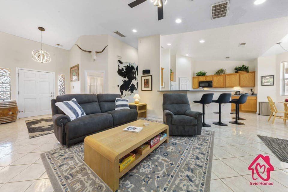 Spacious living room with cozy seating, open layout, and a welcoming flow into the kitchen.