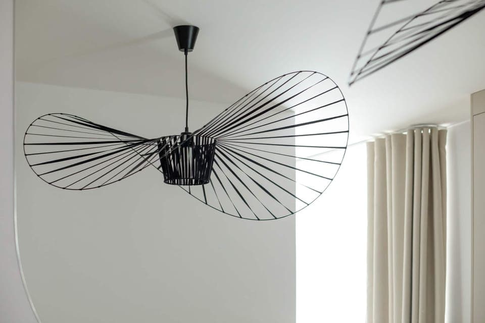 The spacious living area features a comfortable sofa bed and a flat-screen television.