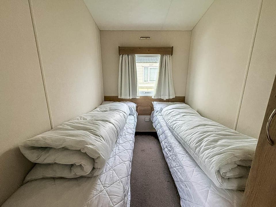 Cozy twin bedroom with natural light and peaceful ambiance