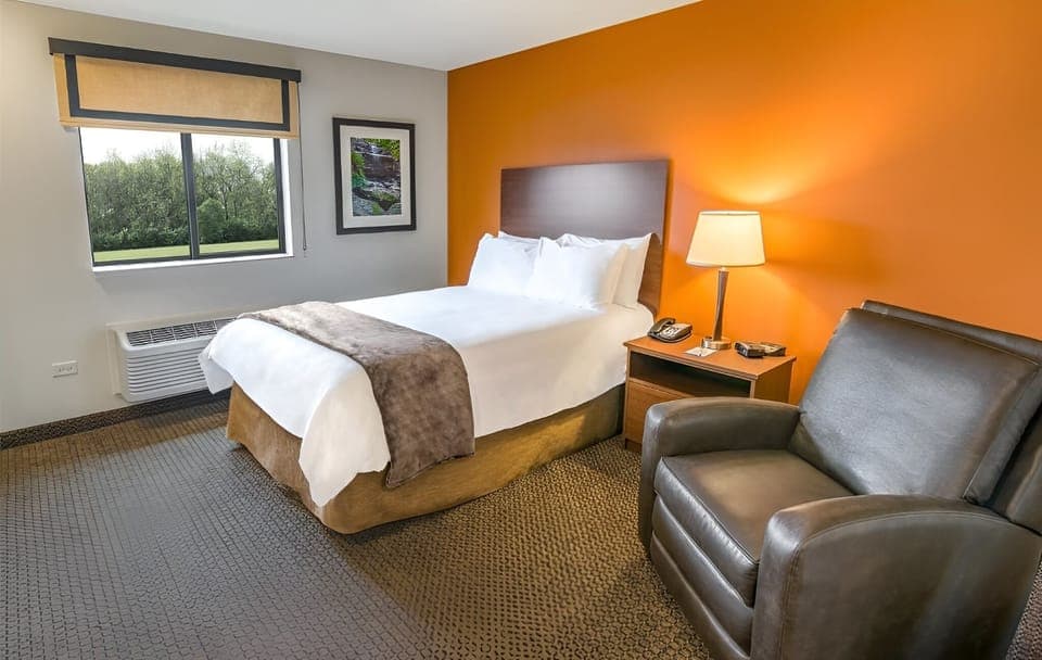 Relax in a cozy king room with lounge chair.