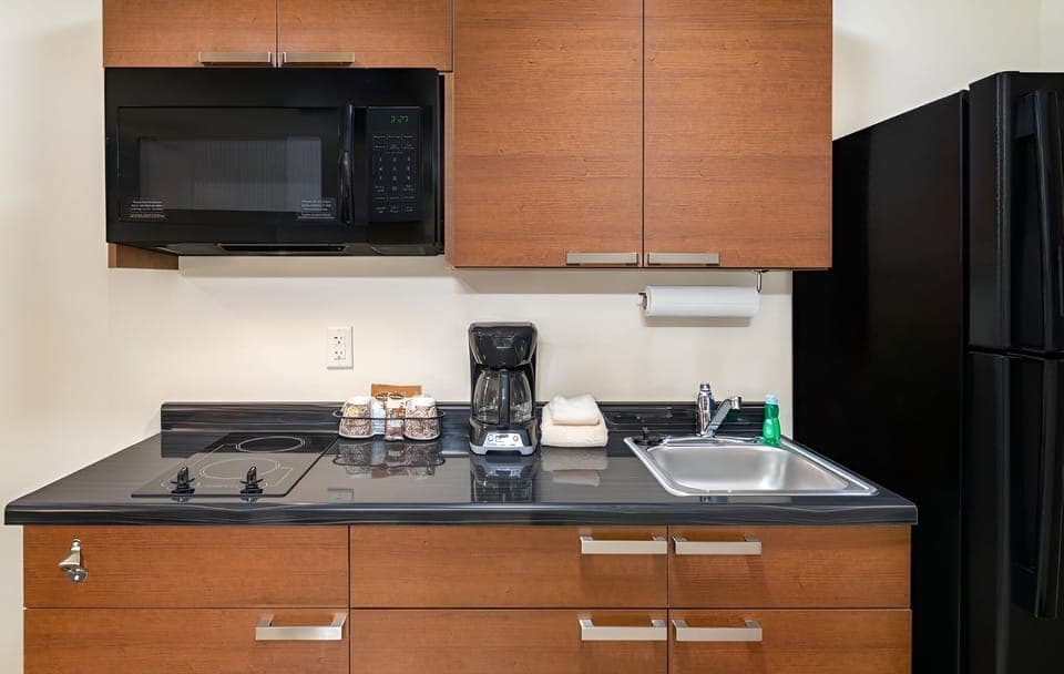 Cook with ease in a tidy kitchenette with full-size fridge.