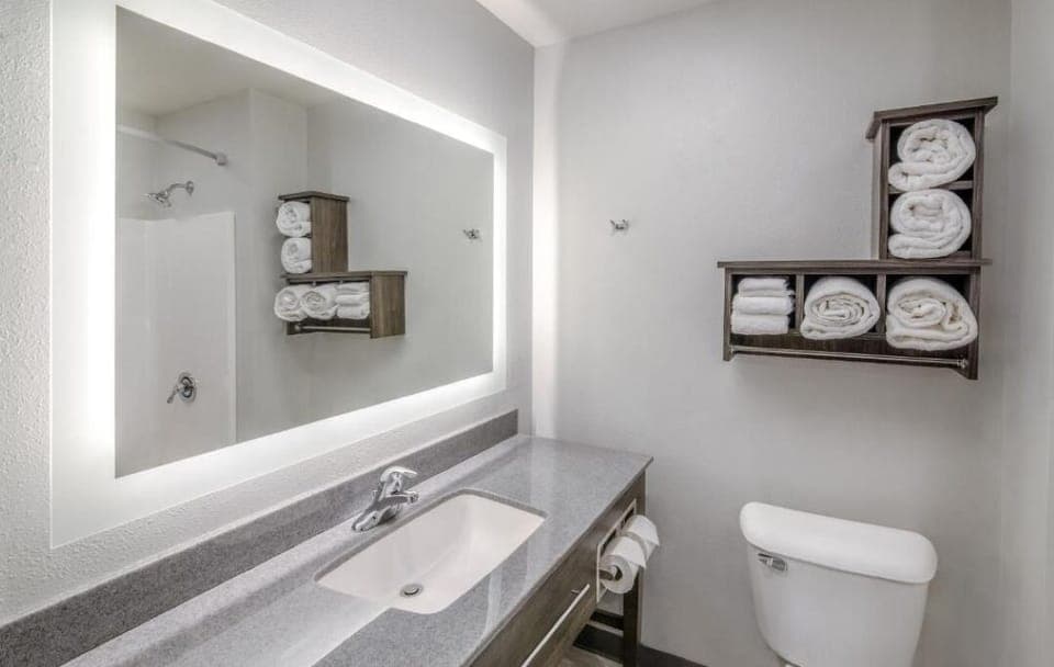 Refresh at the bright vanity with plush towels ready.