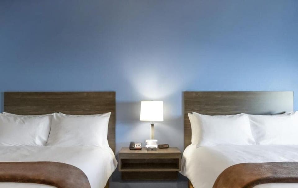 Drift off in crisp linens with warm bedside lighting.