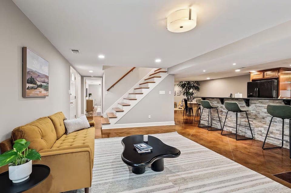 A bright and open living area featuring a cozy yellow sofa.