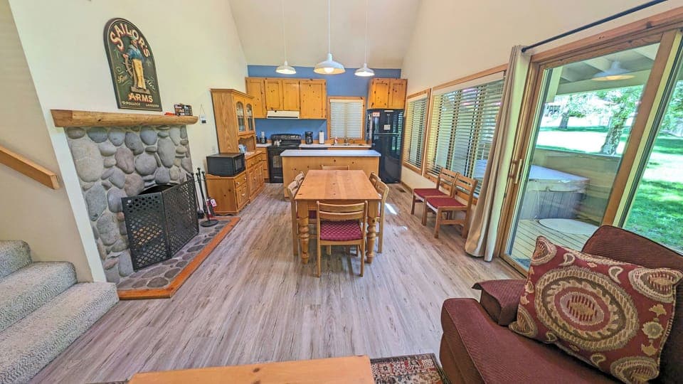 A gas-light wood fireplace wrapped in river rock